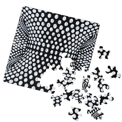 Black and white patterned puzzle with scattered pieces on a white background