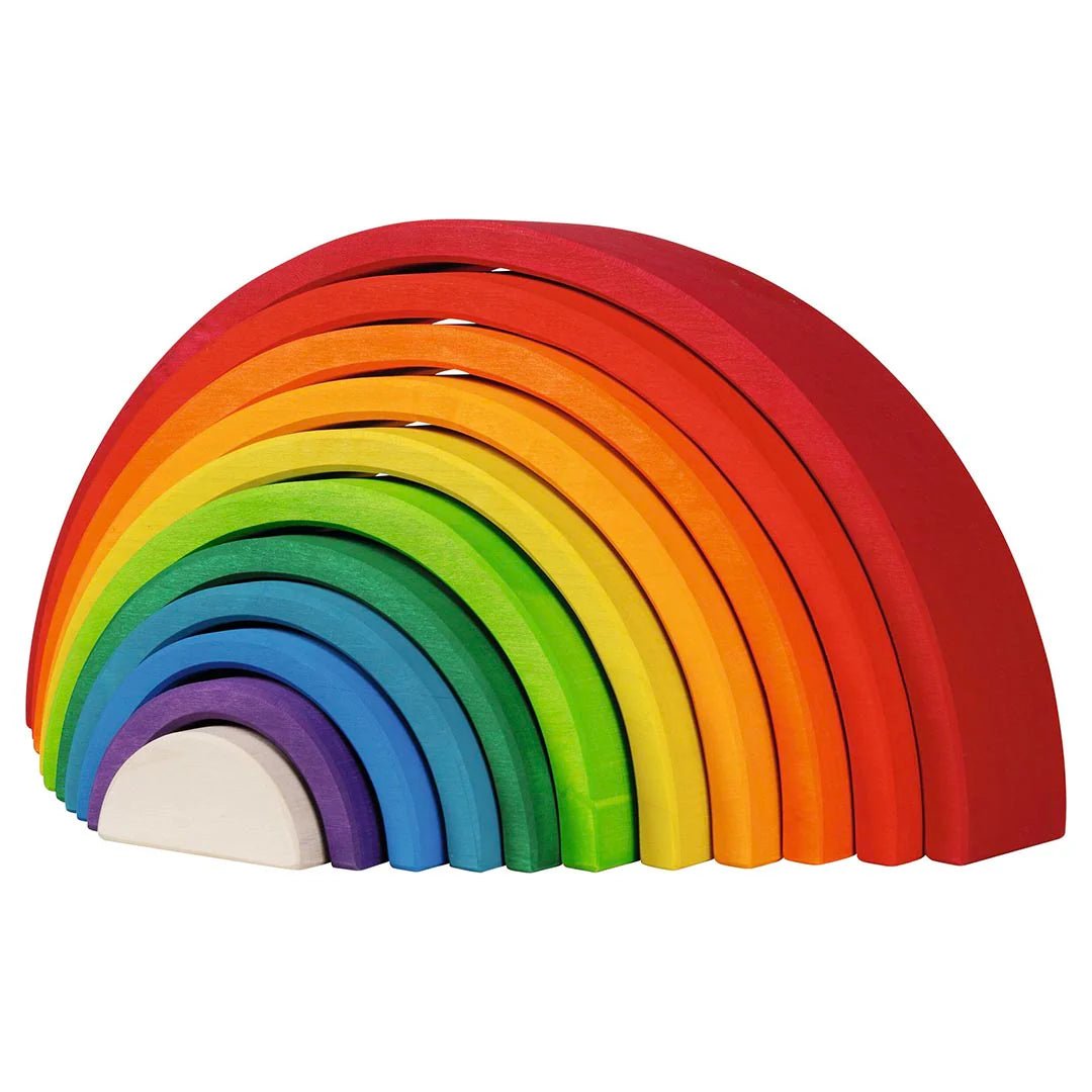 Set of colorful wooden rainbow-shaped blocks on a white background