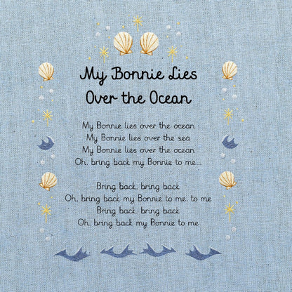 A light blue fabric print featuring the nursery rhyme 'My Bonnie Lies Over the Ocean' with decorative seashells, and stars