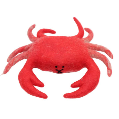 Felted red crab on a white surface