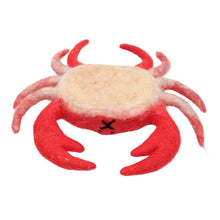 Upside down felted red crab with a tan underbelly on a white background