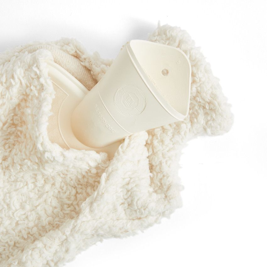 White silicone cup on a soft, textured white surface