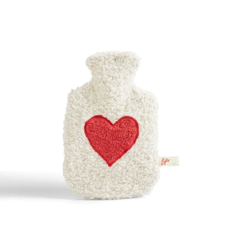 White knitted hot water bottle with a red heart on a white background