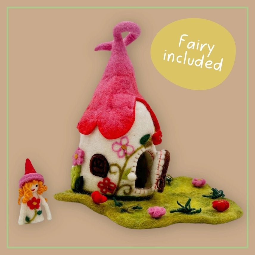 Felt fairy house with pink roof and small fairy figure on a beige background