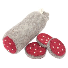 Felted salami and 3 slices on a white background
