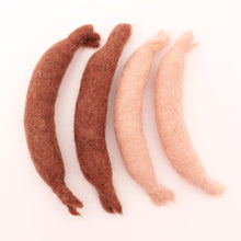 4 felted sausage links on a white background