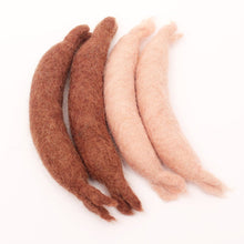 2 light and 2 dark felted sausages on a white background