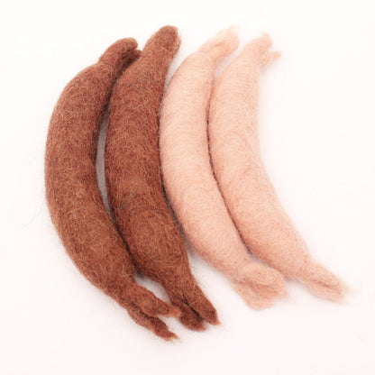 2 light and 2 dark felted sausages on a white background