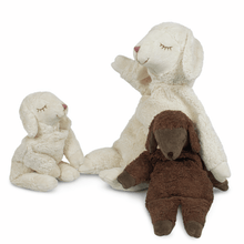 Large white, small white, and small brown sheep stuffed animals on a white background