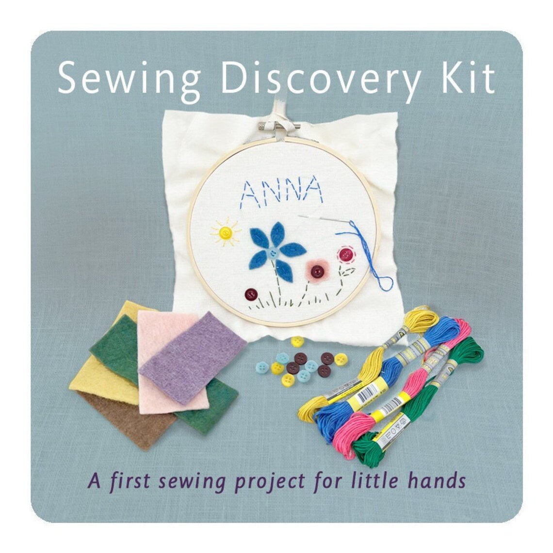 Sewing discovery kit with embroidery hoop, threads, and fabric squares on a blue background