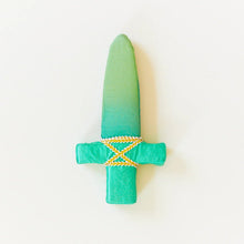 Green silk dagger with gold trim on a white background