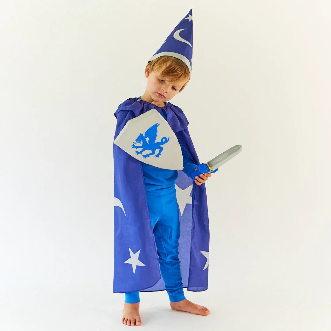 Child in a blue wizard costume with a hat, cape, sword, and shield on a white background