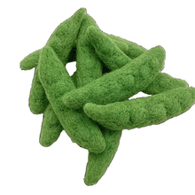 12 felted snow peas on a white background