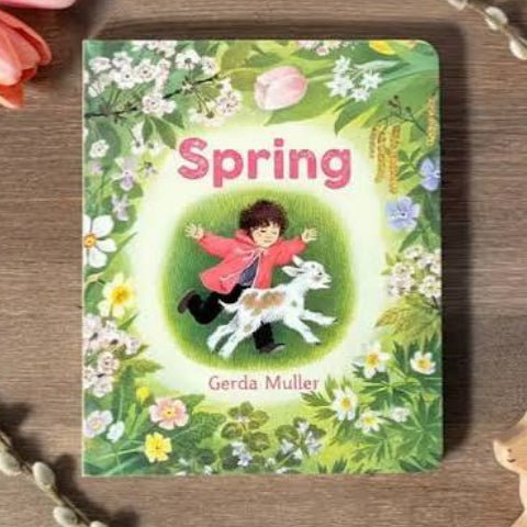 Spring Board Book by Gerda Muller on a wooden surface
