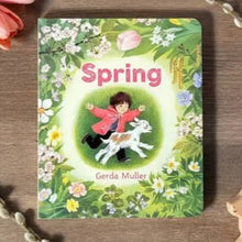 Spring Board Book by Gerda Muller on a wooden surface