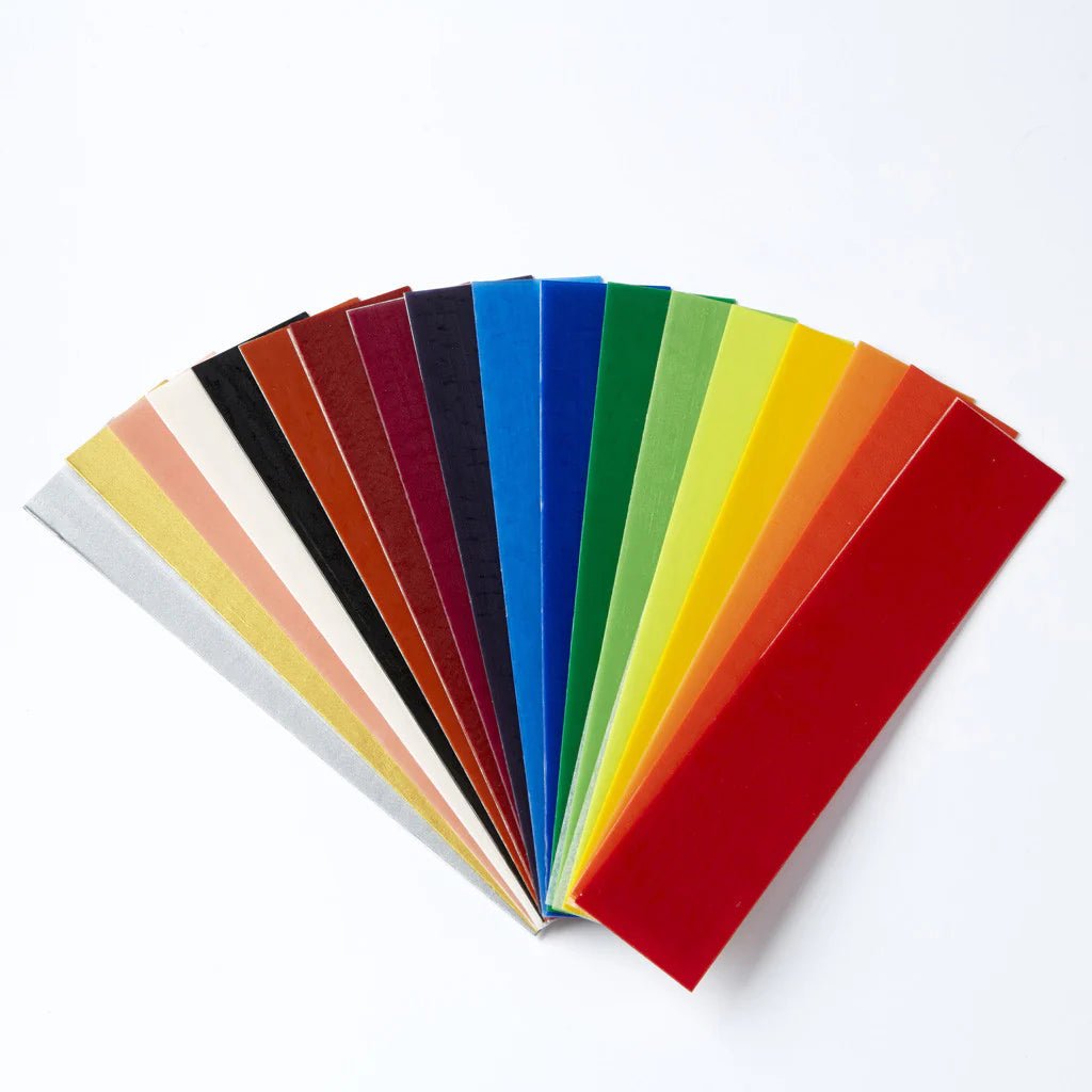 18 narrow sheets of decorating wax in various colors on a white background