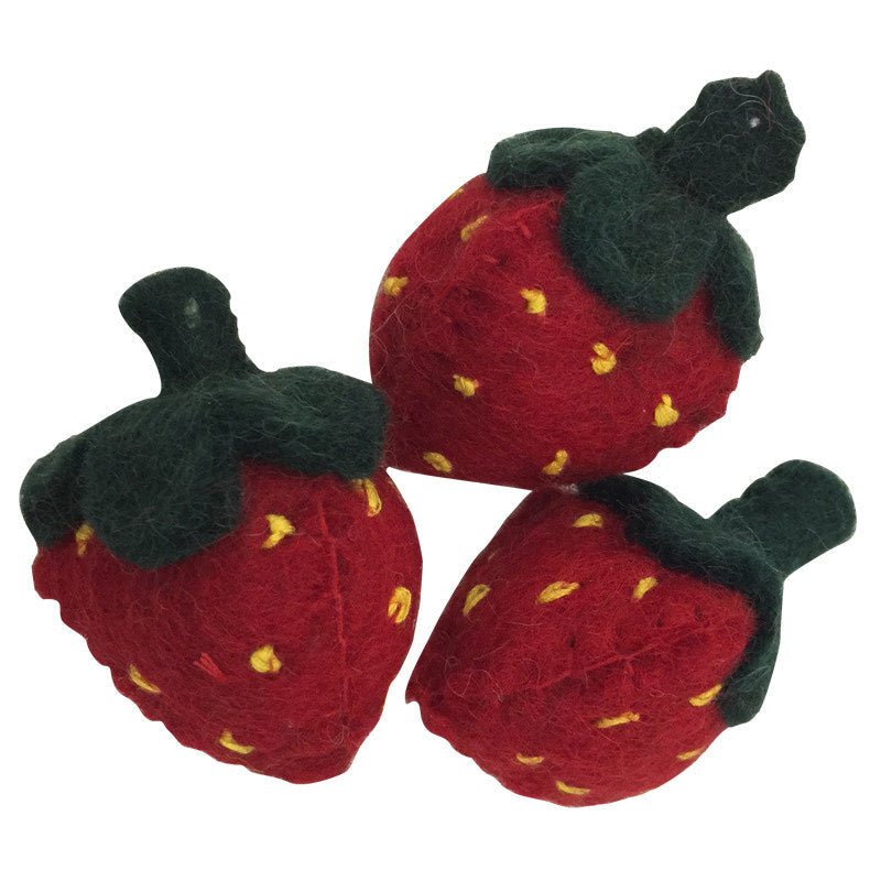 Three felted strawberries on a white background