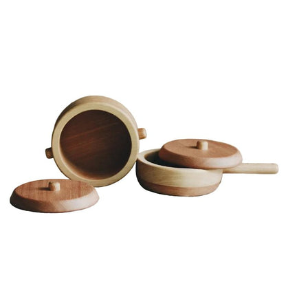 Wooden containers with lids on a white background