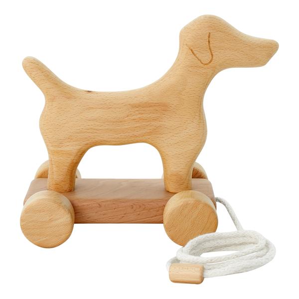 Side view of wooden dog-shaped pull toy with wheels on a white background