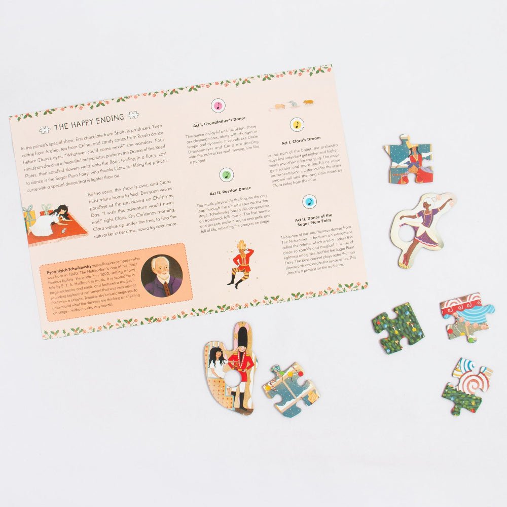 A printed story board or instruction sheet titled 'THE HAPPY ENDING' with colorful illustrations and several small illustrated puzzle-piece pieces arranged around it on a clean white background.