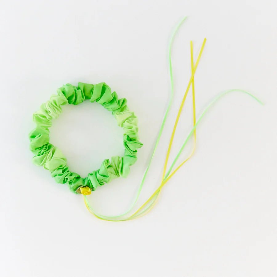 Green silk garland with yellow rose and ribbons on a white background