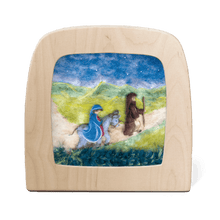 Silhouette of Joseph leading Mary on a donkey