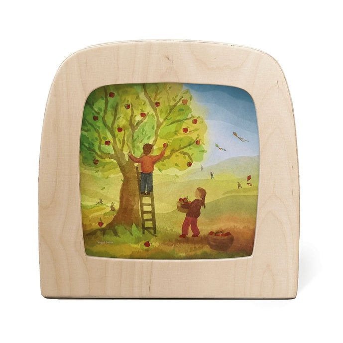 Silhouette of two children picking apples from a tree 