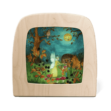 Silhouette of a yellow fairy in the forest, surrounded by woodland creatures