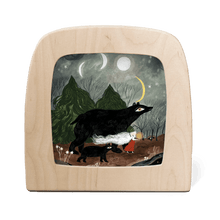 Silhouette of two black bears and a person in a forest at night.