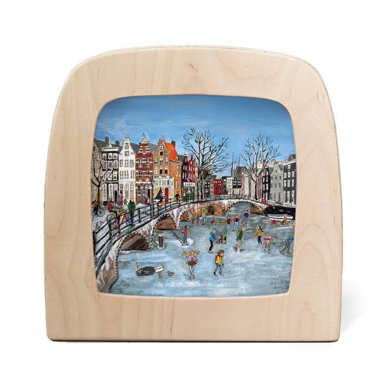 Wooden picture frame with a painted scene of people skating on a canal.