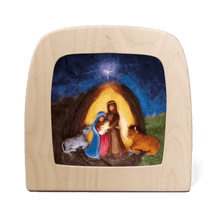 Silhouette of a Nativity scene featuring Mary, Joseph, Baby Jesus, and two cows