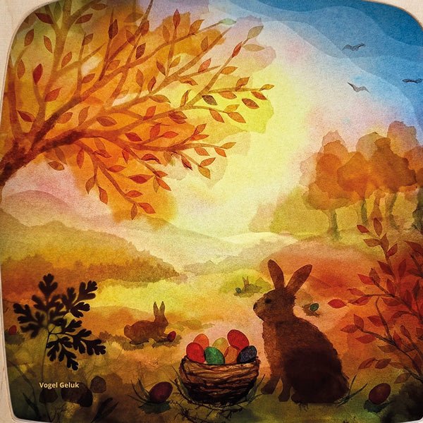 Watercolor painting of two rabbits with a basket of Easter eggs in an autumnal landscape.