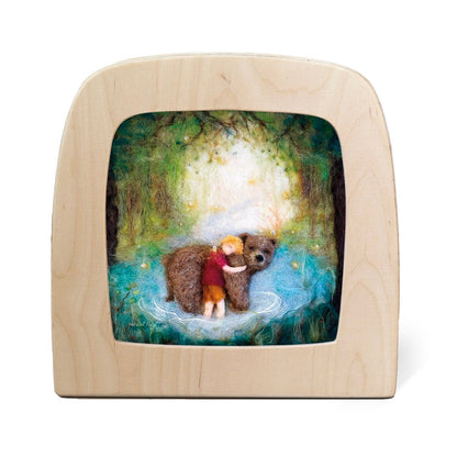 Silhouette of a child hugging a bear in the woods
