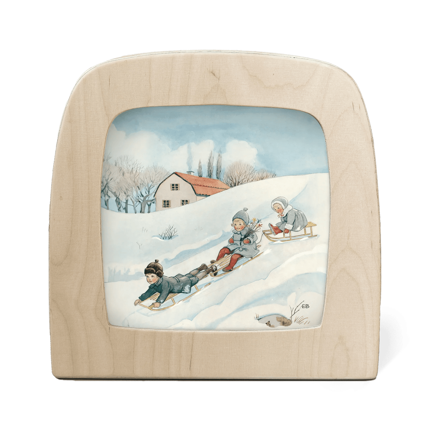 Silhouette of three children sledding down a snowy hill, with house in the background