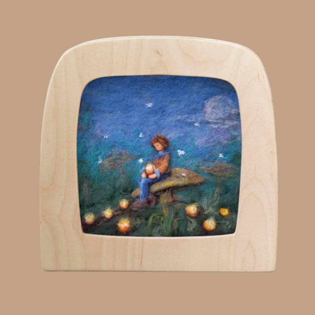 Wooden frame with a scene of a child sitting on a toadstool under a starry sky.