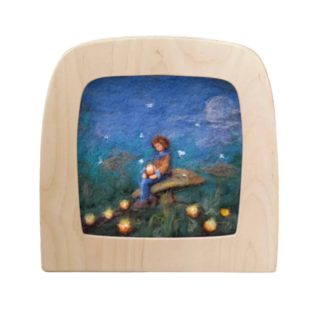 Wooden frame with a scene of a child sitting on a toadstool under a starry sky.