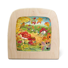 Toverlux lampdisplaying a colorful whimsical forest illustration featuring red-and-white mushrooms, autumn leaves, a bird, a small house, and a fox, shown on a white background.