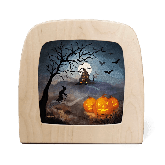 Silhouette of a Halloween scene featuring a witch, bats, and jack-'o-lanterns on a dark background 