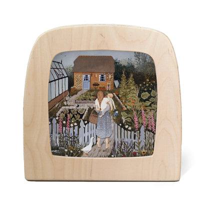 Silhouette of mother and baby walking down the pathway to their red brick house and garden