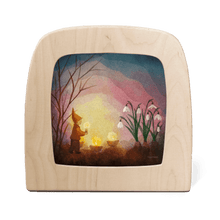Silhouette of a gnome, candles, and flowers