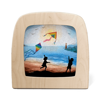 Silhouette of two children flying kites at the beach