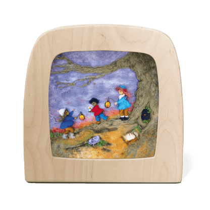 Children standing under a tree holding lanterns made out of natural materials