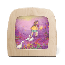 Wooden frame with silhouette of a girl in a purple flower field followed by white geese
