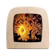 Silhouette with a nature-themed design featuring a person, woodland creatures, and leaves.