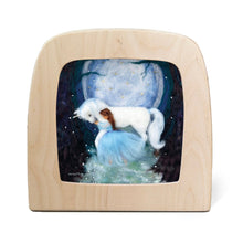 Silhouette of a girl in a blue dress hugging a unicorn with the moon in the background