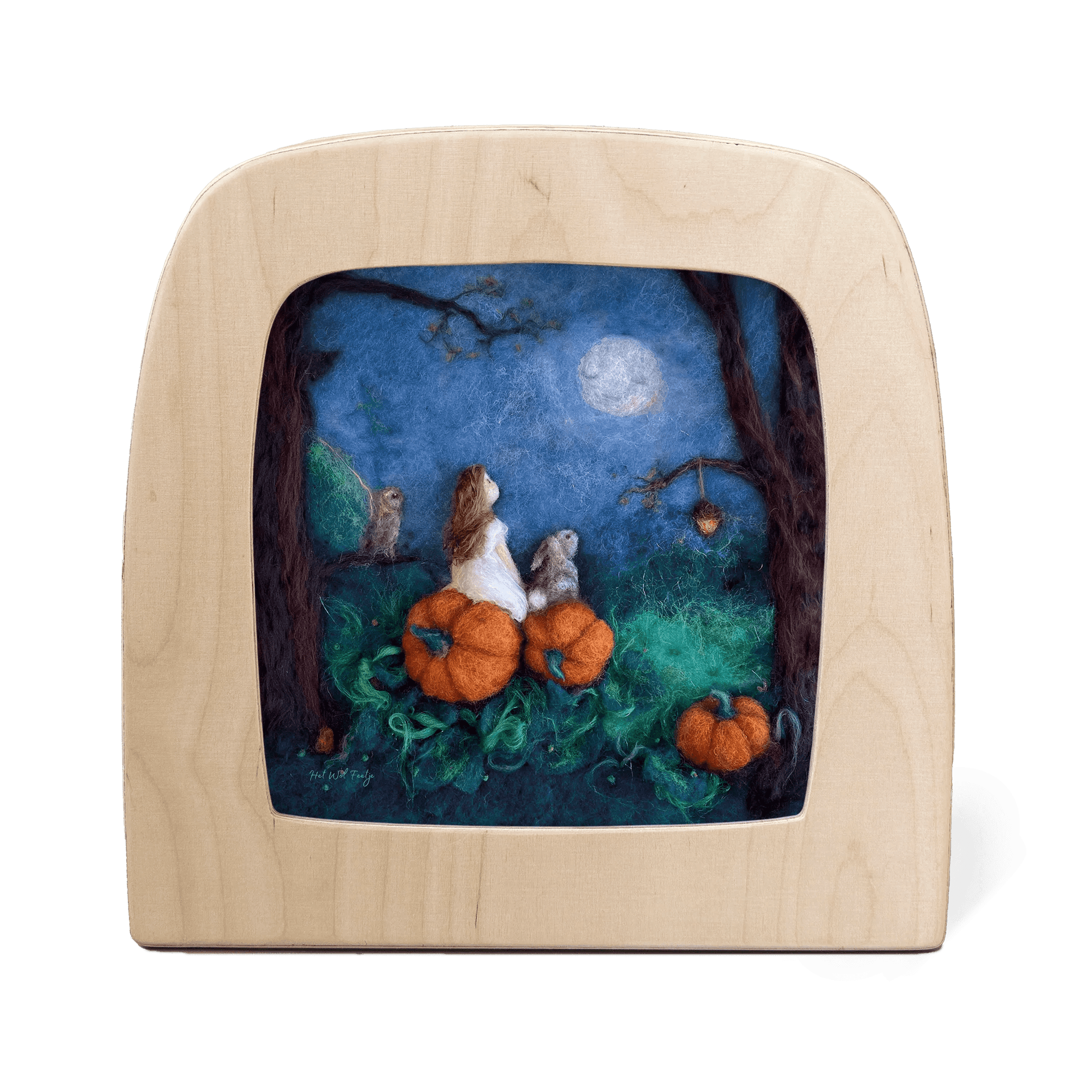 Silhouette of a girl and a rabbit sitting on pumpkins looking at the moon