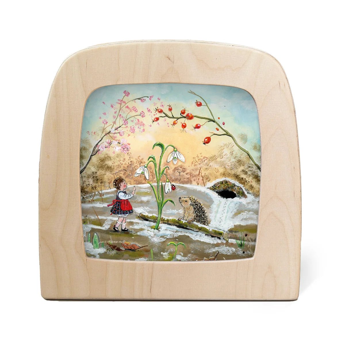 Toverlux lamp showing a painted winter landscape scene with a child, snowdrops, a hedgehog, a small waterfall, and pink blossoms.
