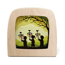 3 children carrying decorative palmpaasstokken