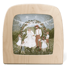 Silhouette of married couple and children under a floral arch