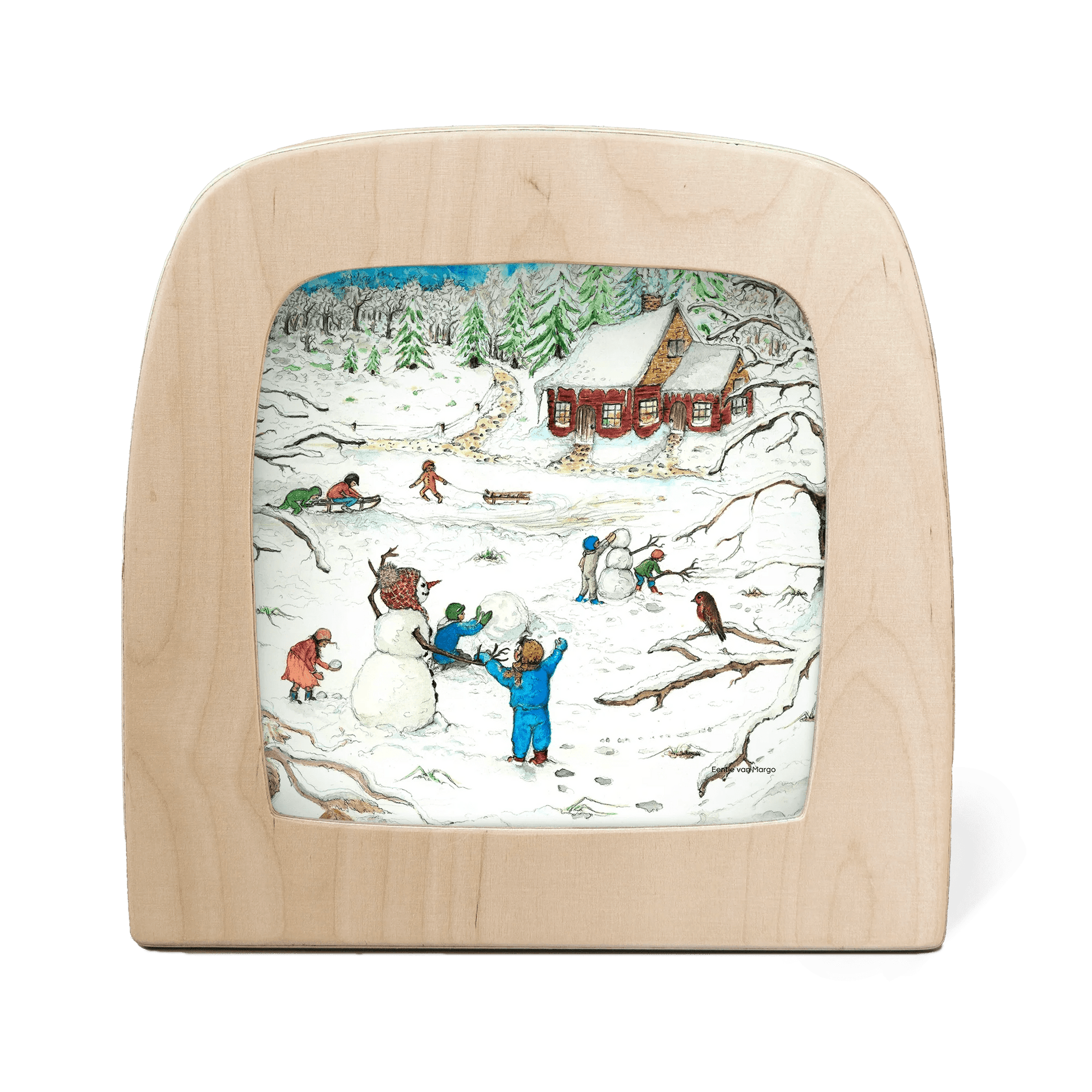 Silhouette of children playing in the snow with a red cottage in the background